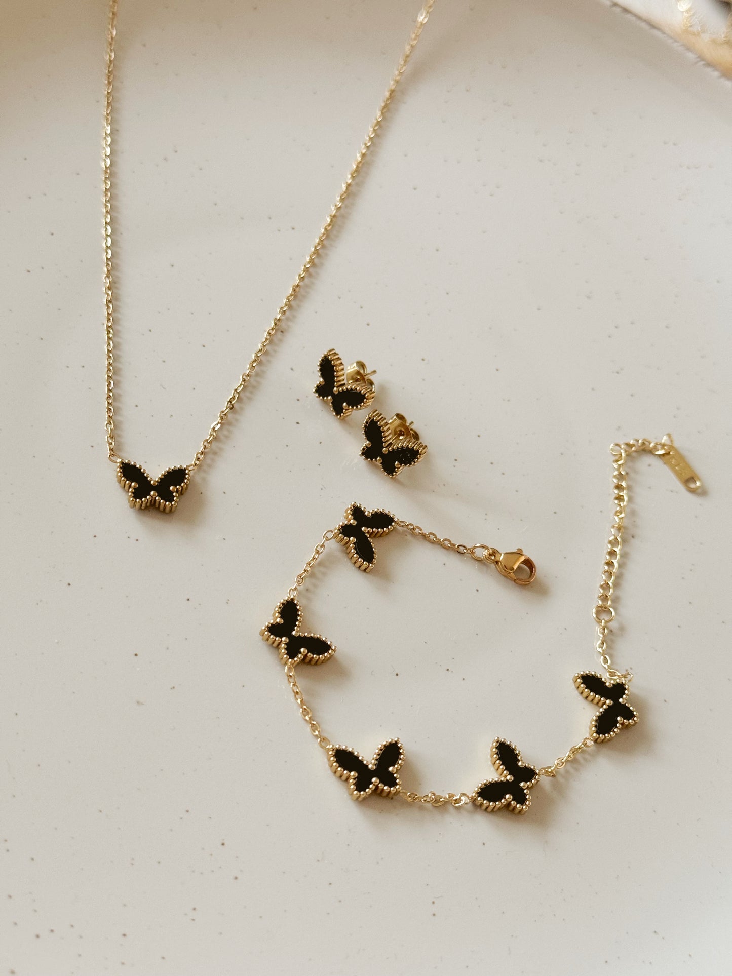 Gold and black van cleef butterfly set