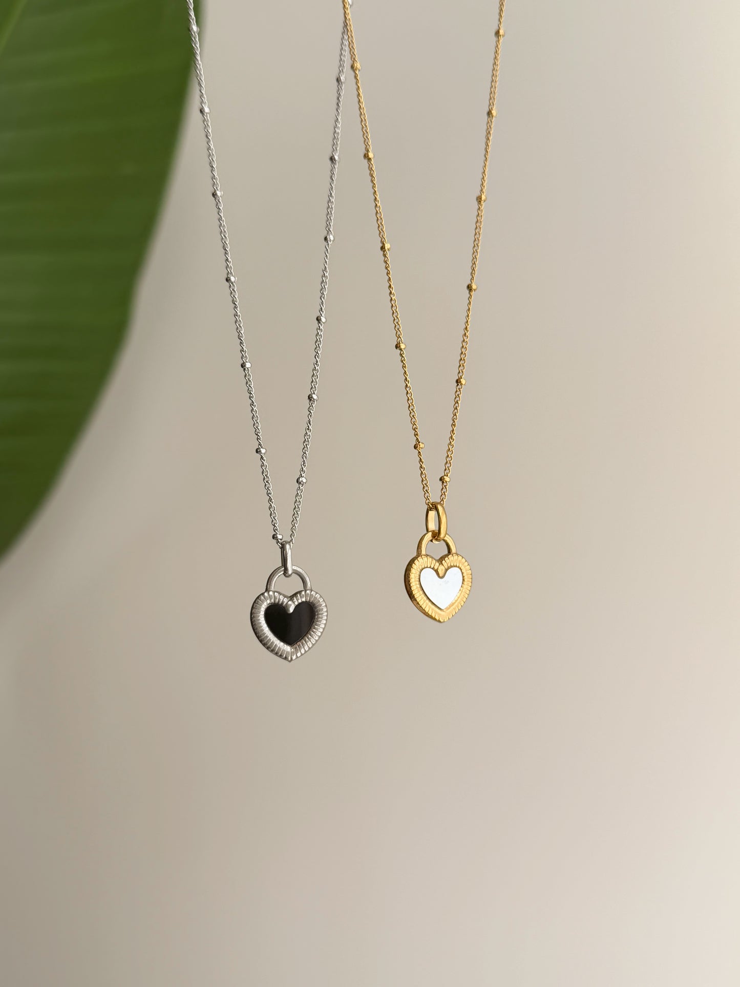 Double sided black and white heart necklace
