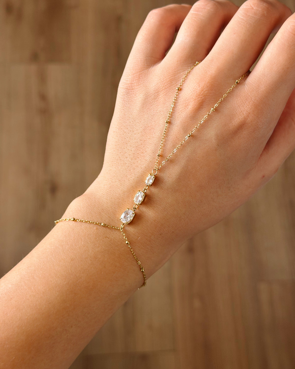 White oval stone Hand chain gold