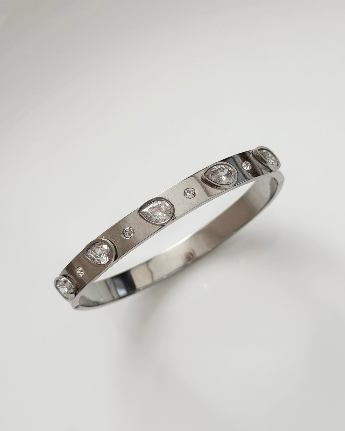 Silver tear drop stone static bracelet