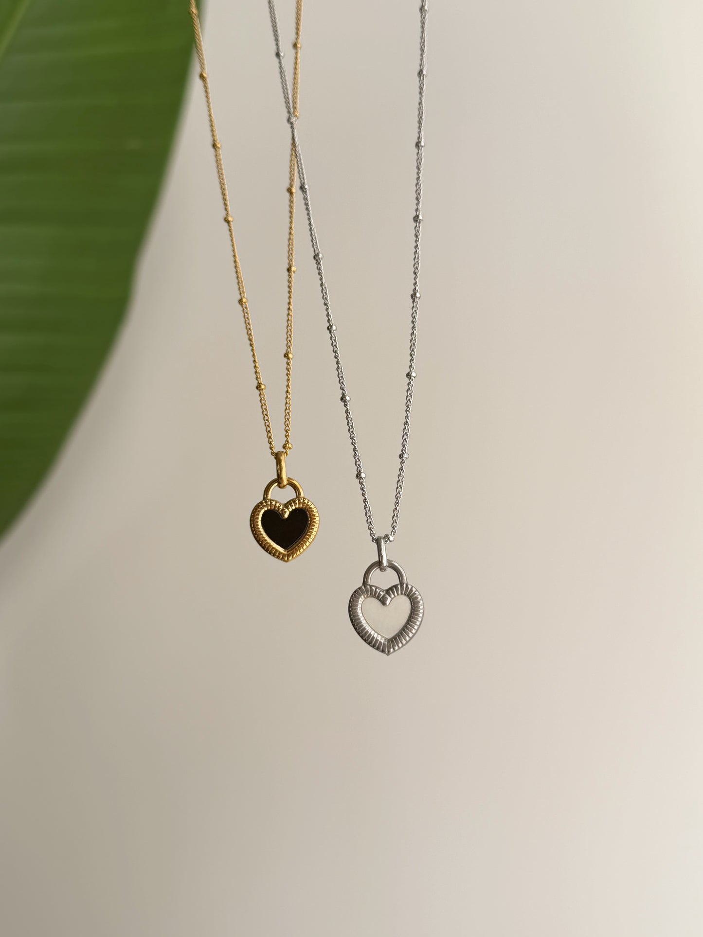 Double sided black and white heart necklace